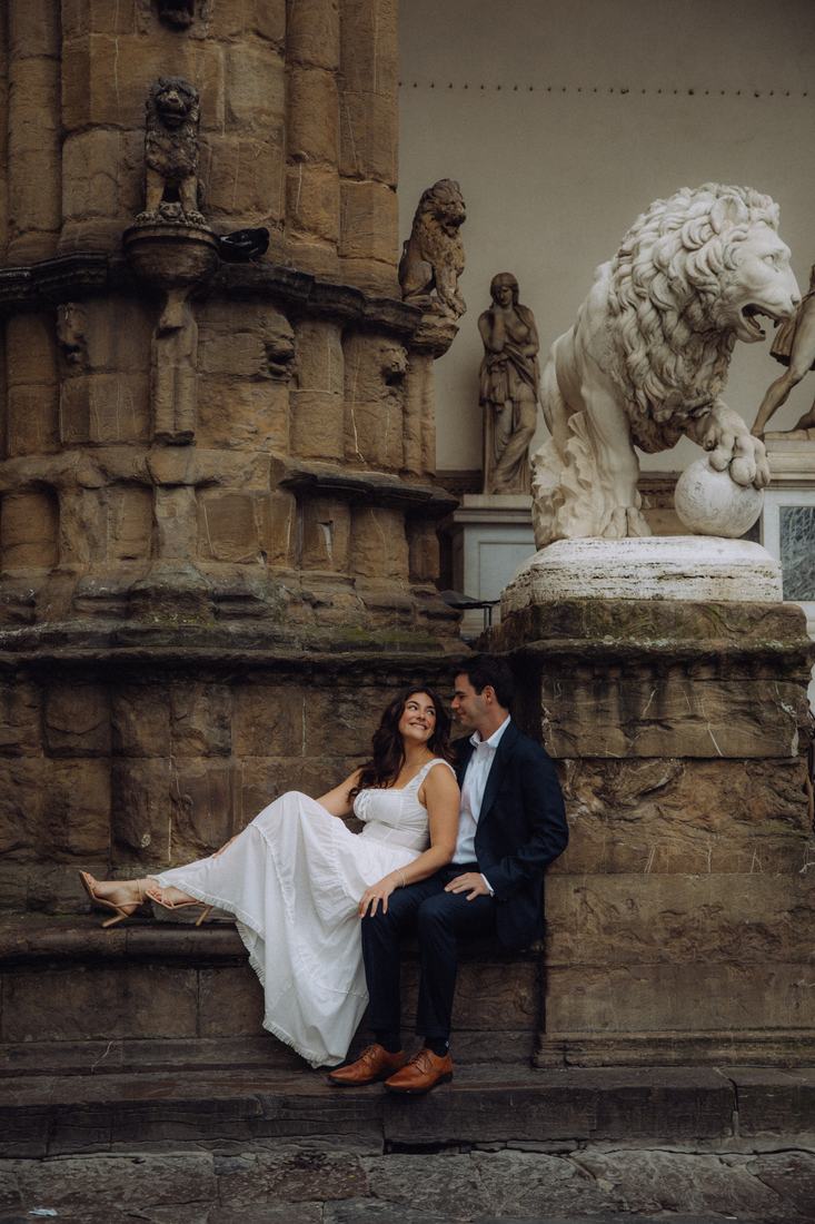 Laughing by the lion statue